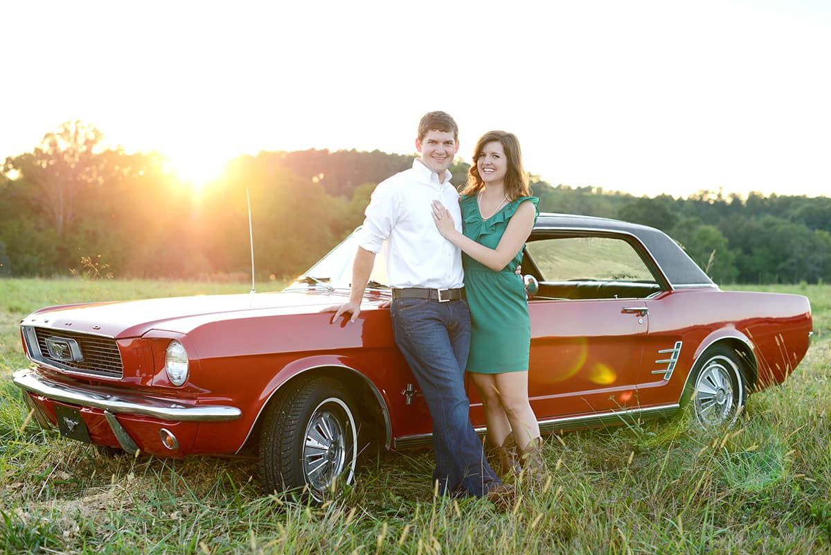 Engagement pictures with an old vintage Ford Mustang car in a field in Clemson, SC