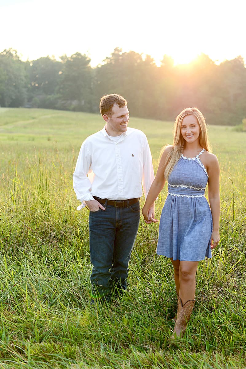 Engagement pictures walking through a field